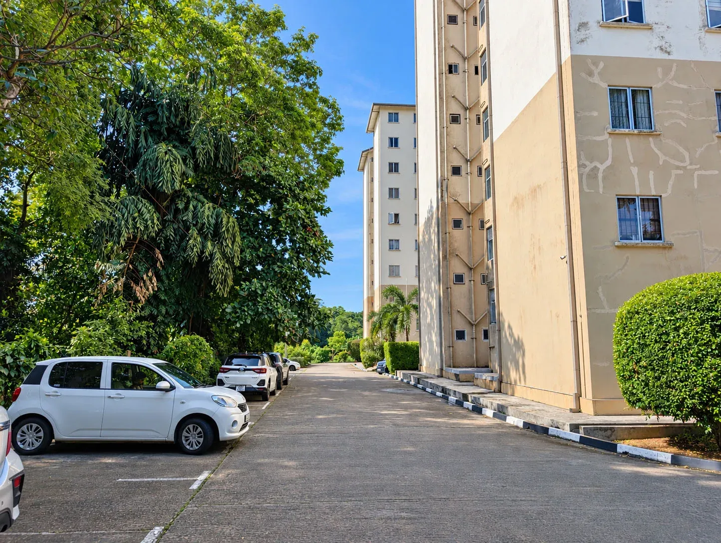 Shared parking area and another exterior view of the apartment building.